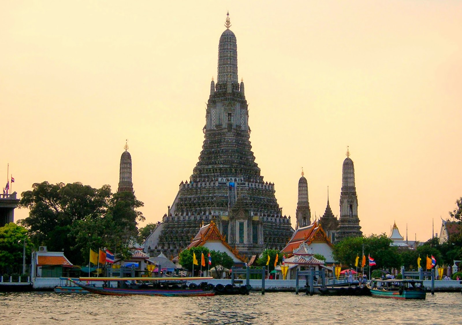 The Temple of Dawn in Bangkok along the river