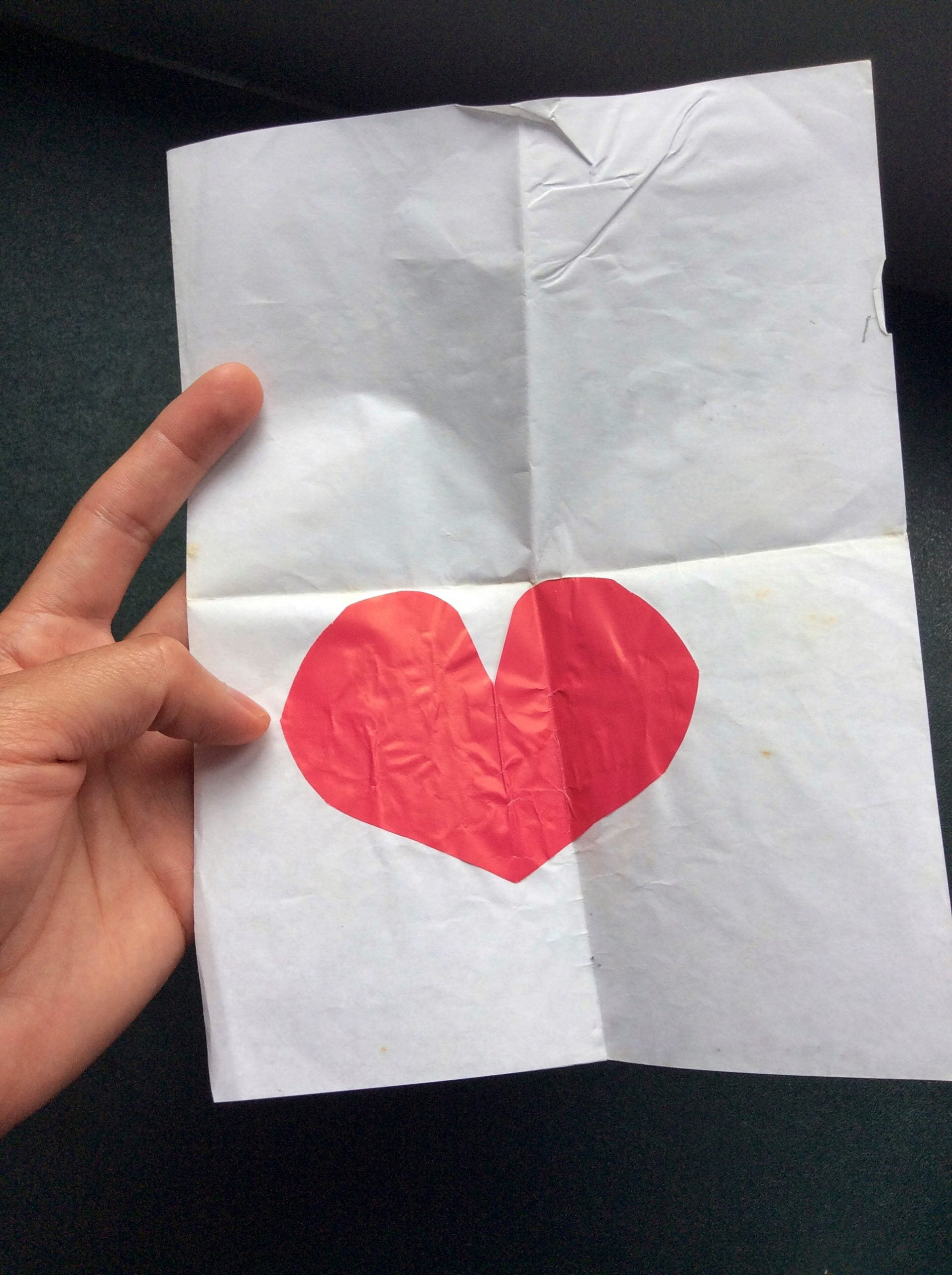 A paper card with a cut-out heart in the middle for Munich