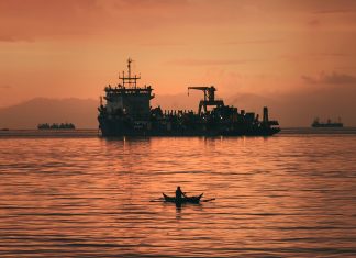 A fisherman returning to shore with his catch