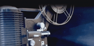 A movie projector showing a countdown on a screen